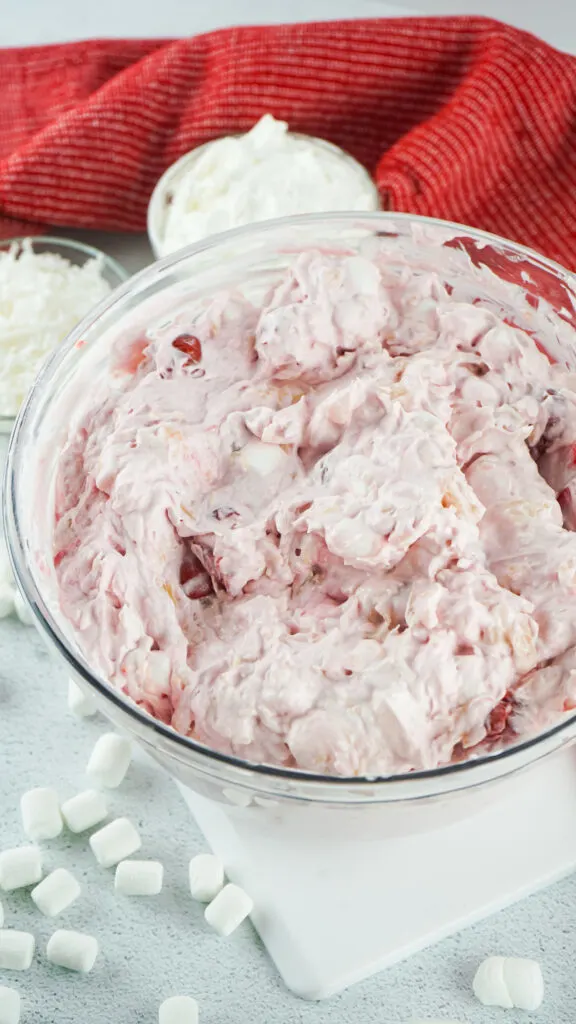 cherry fluff mixed in large clear bowl