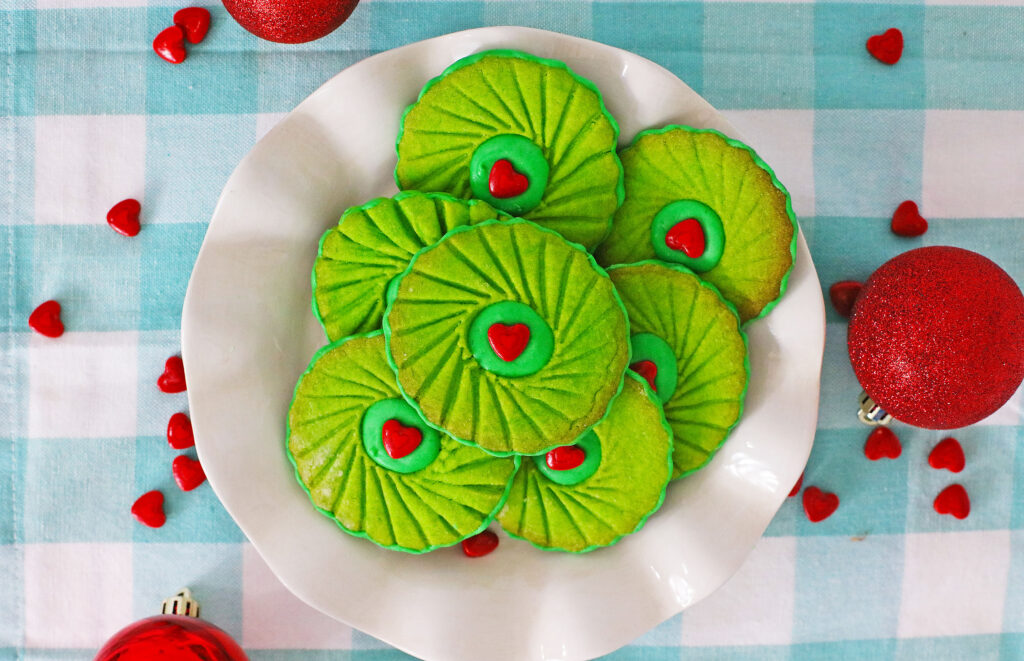 top view of grinch thumbprint cookies on a white plate