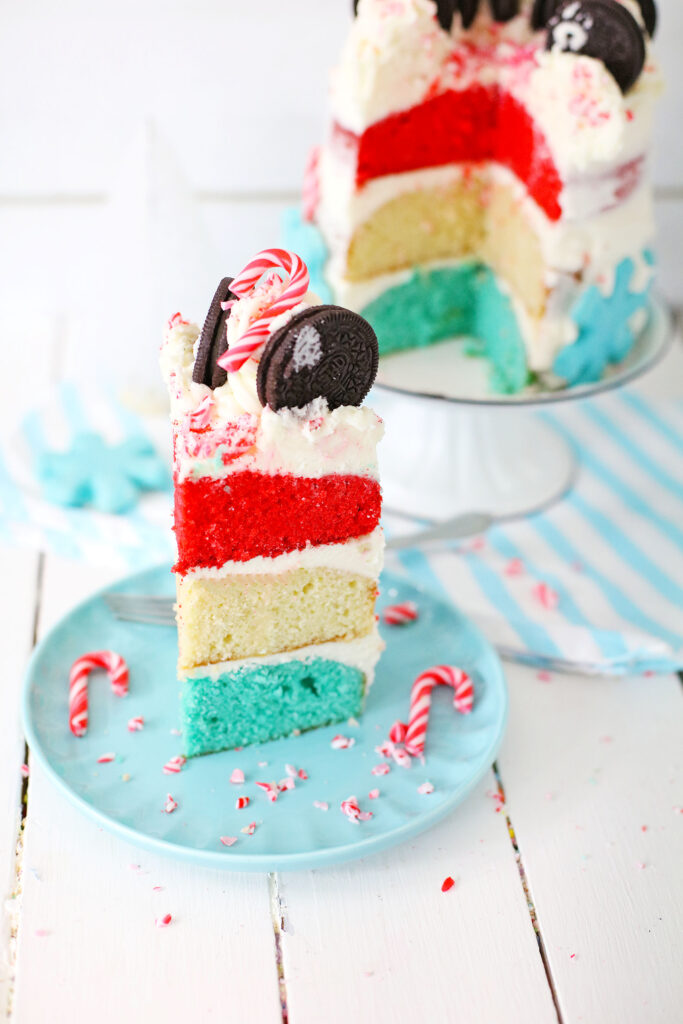 sliced of layered peppermint cake on a round blue plate