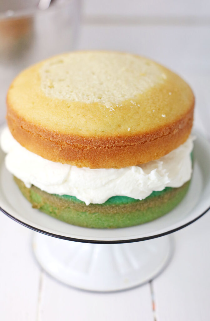 white cake layer on top of aqua cake layer