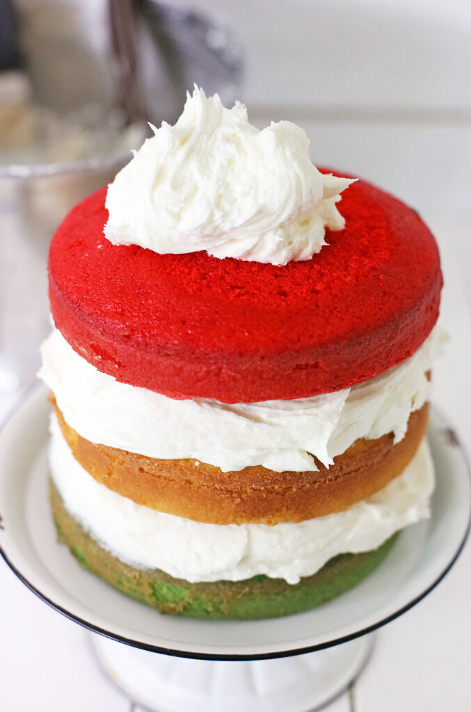 red layer of cake with frosting on top