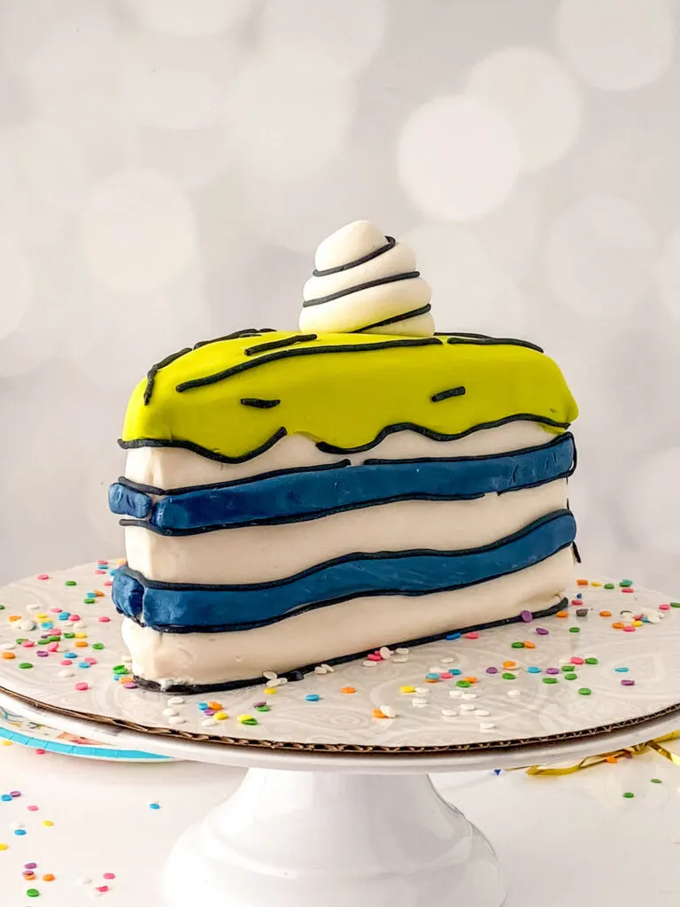 slice of cartoon cake on cake stand