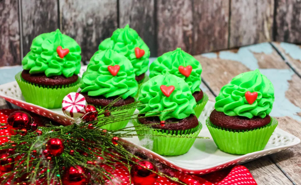 grinch cupcakes on white serving tray