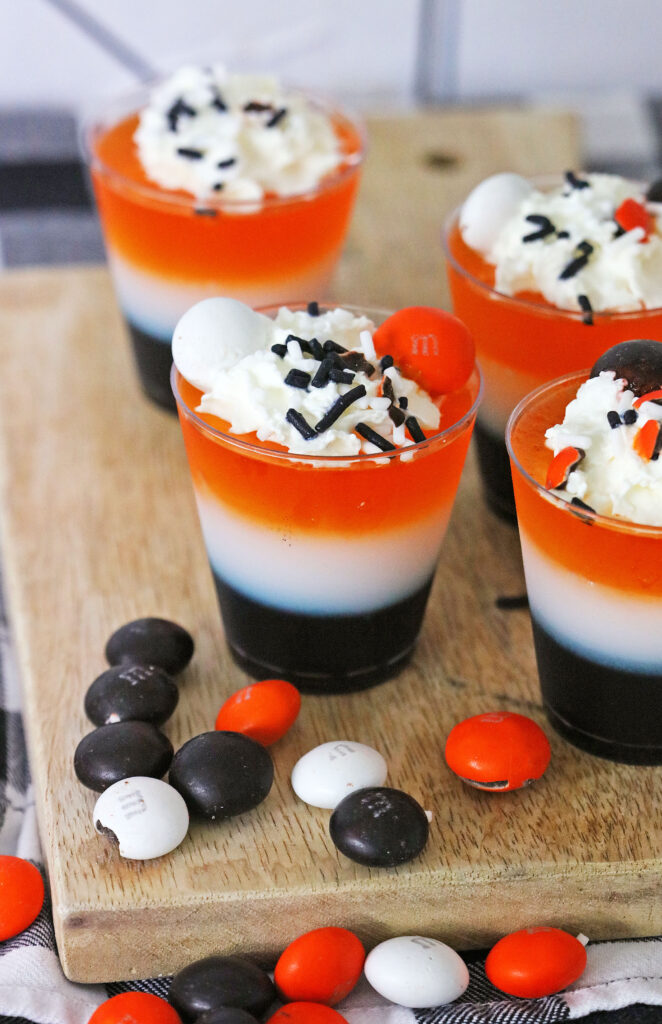 halloween jello shots with halloween m&ms on serving tray