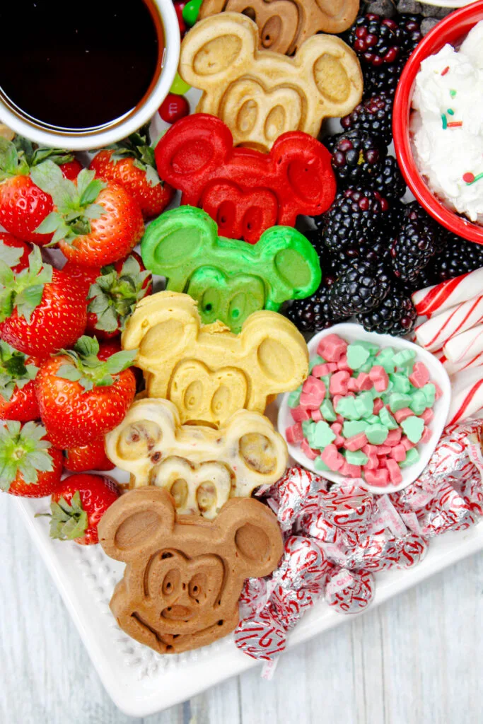 colorful mickey waffles on a mickey mouse charcuterie board