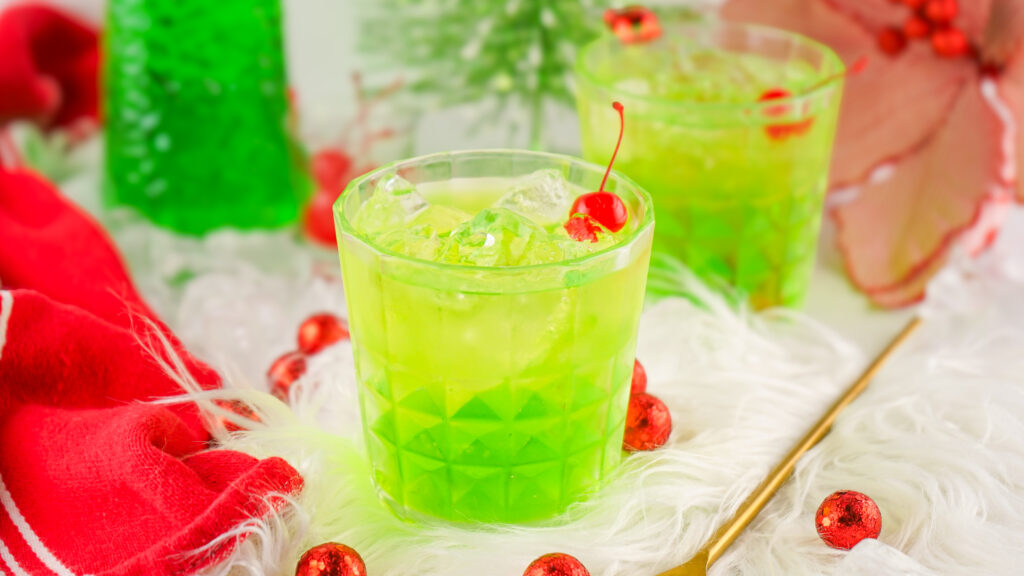 glasses of grinch cocktails on a christmas table