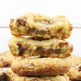 Side view of Deep Dish Chocolate Chip Cookies on a plate