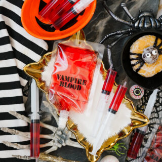 Image of Bloody Jello Shot Syringe on a halloween backround.