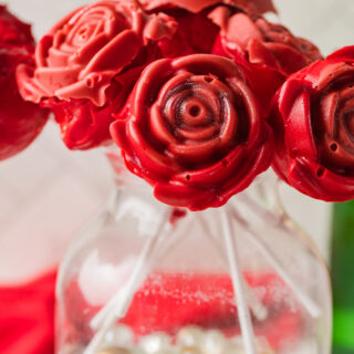 close up view of homemade valentine rose cake pops in jar