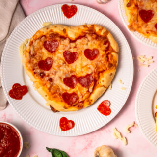 Overhead image of Heart Shaped Pizzas on a plate.