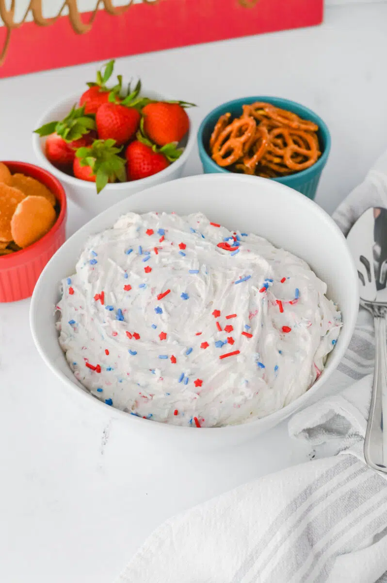 Red White Blue Funfetti Dip in a bowl with dip-ables in the background 
