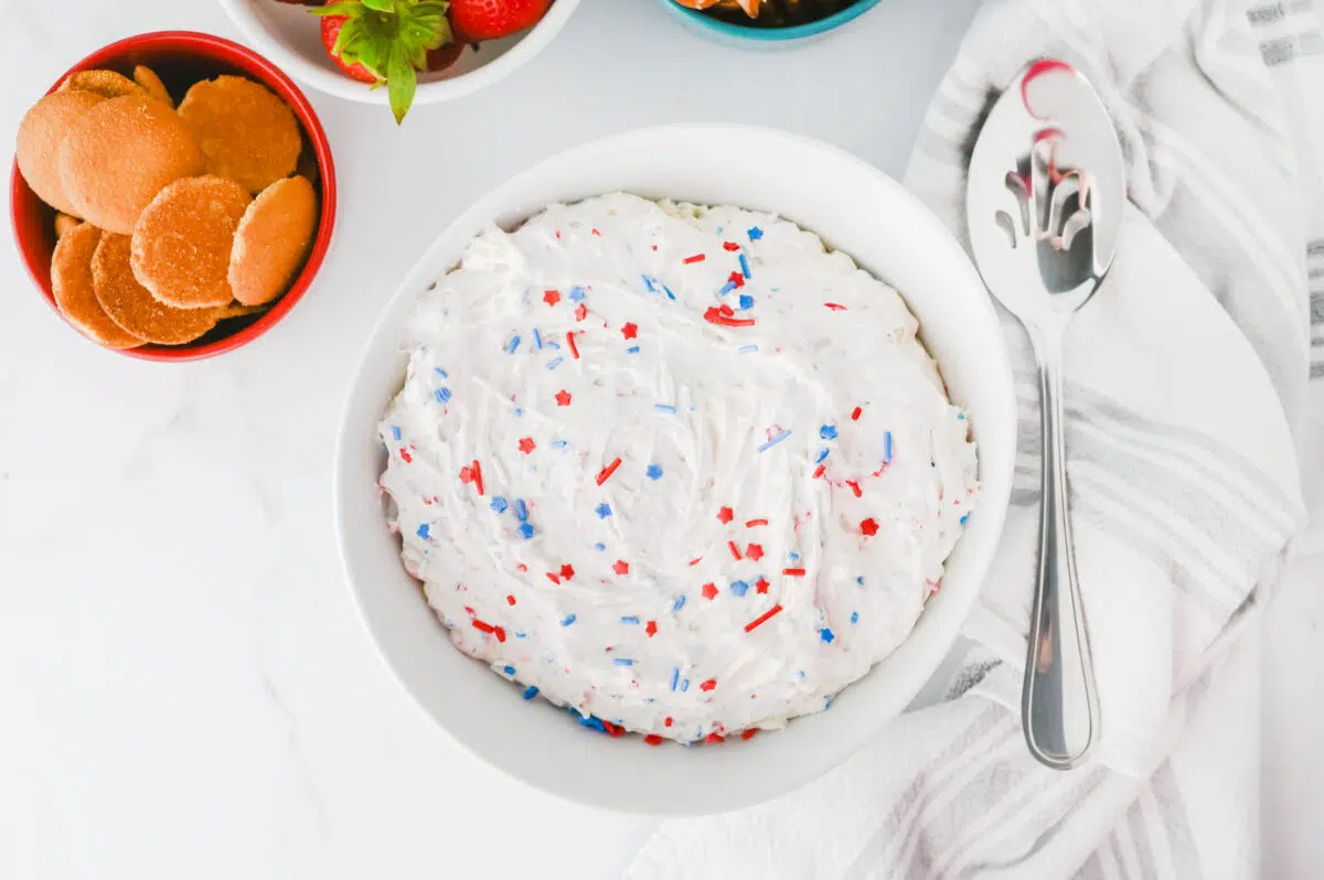 Red White Blue Funfetti Dip in a bowl with dip-ables in the background 